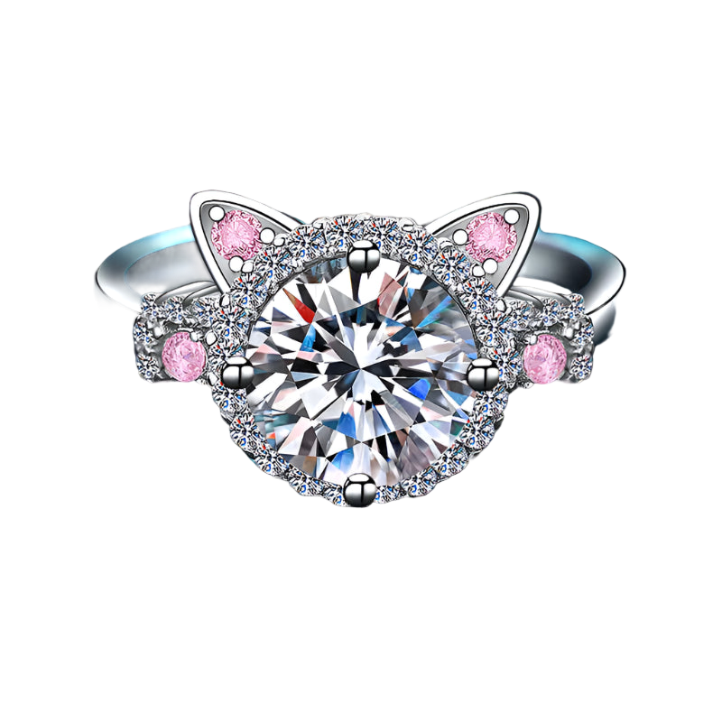 Silver ring with cat ear design and pink gemstones on a blue textured background