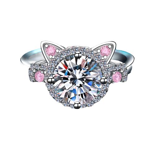 Silver ring with cat ear design and pink gemstones on a blue textured background