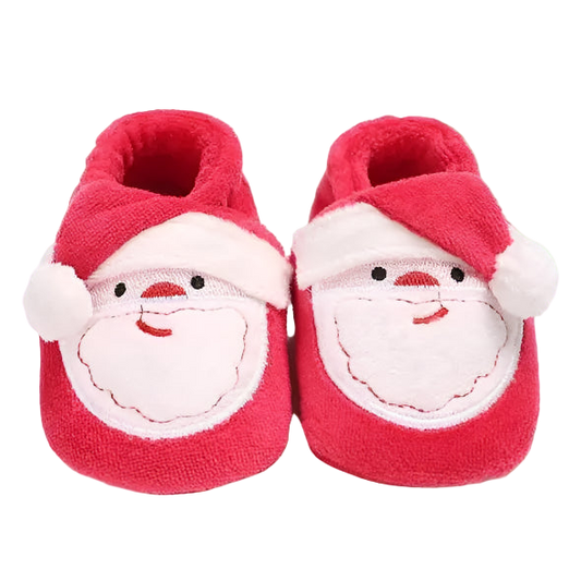 Red baby shoes with Santa face design on a white background