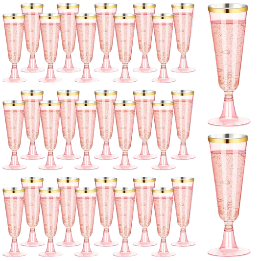 Set of pink champagne flutes with gold rims on a white background
