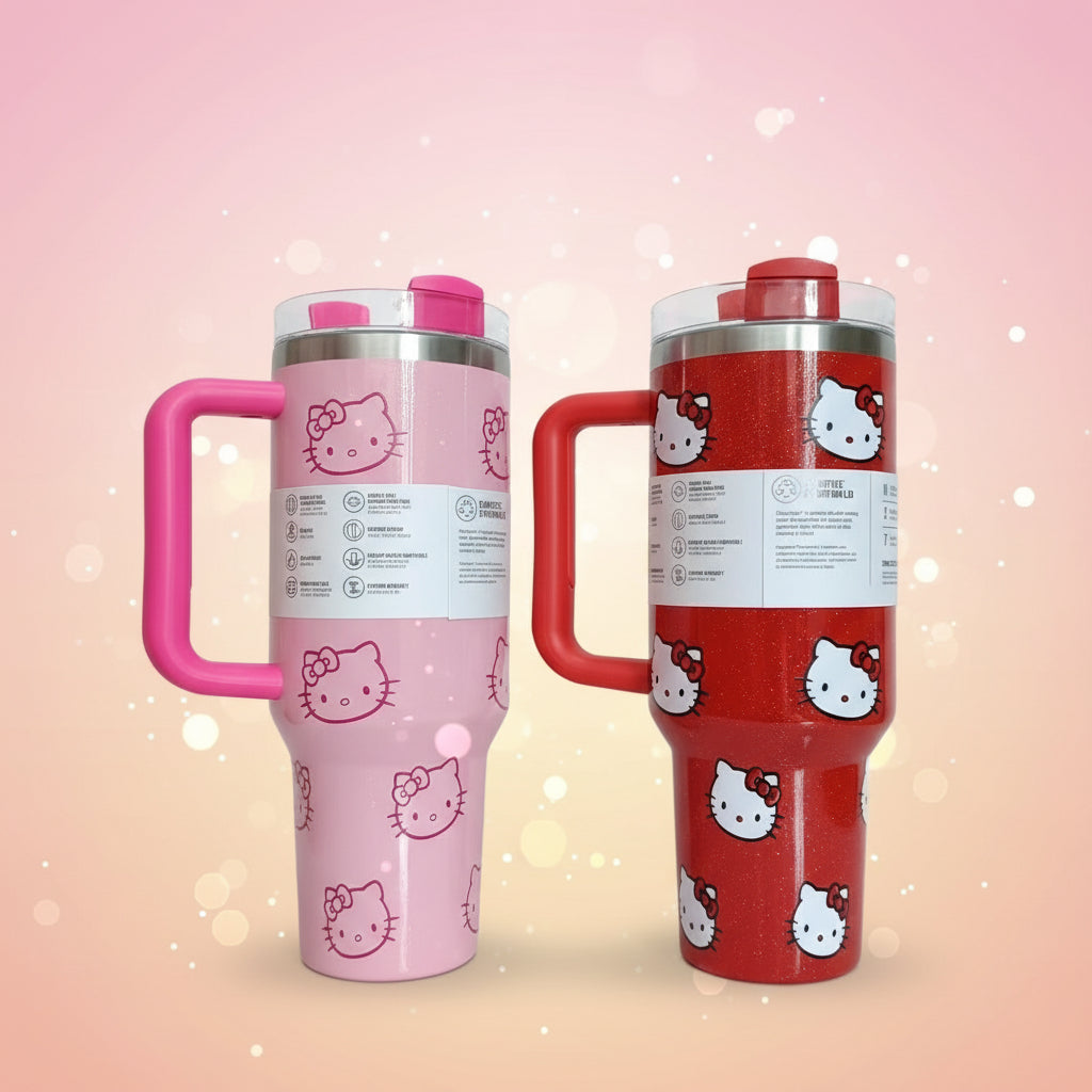 Two Hello Kitty-themed tumblers, one pink and one red, on a white surface with cardboard boxes in the background.