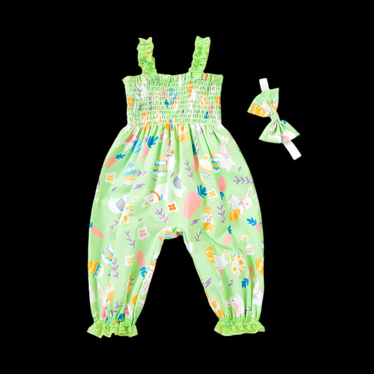 Green children's romper with colorful pattern and matching headband on a dark blue background