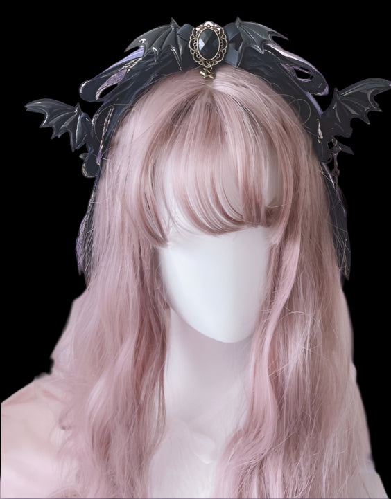 Mannequin head with pink wig and decorative headband against a soft pink background
