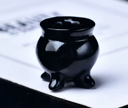 Black ceramic incense burner on a white surface