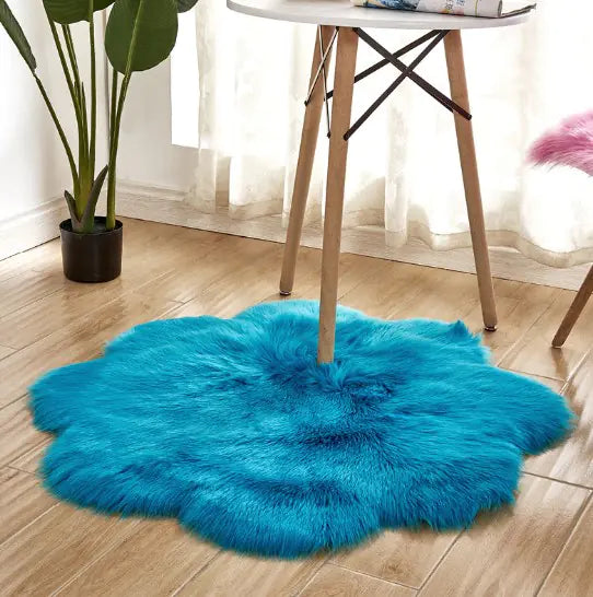 Blue fluffy rug on a wooden floor with a chair and plant in the background