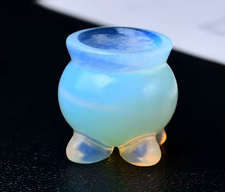 Opaline glass vase with a gradient of blue and green on a dark background