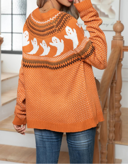 Person wearing an orange sweater with ghost patterns in a home setting
