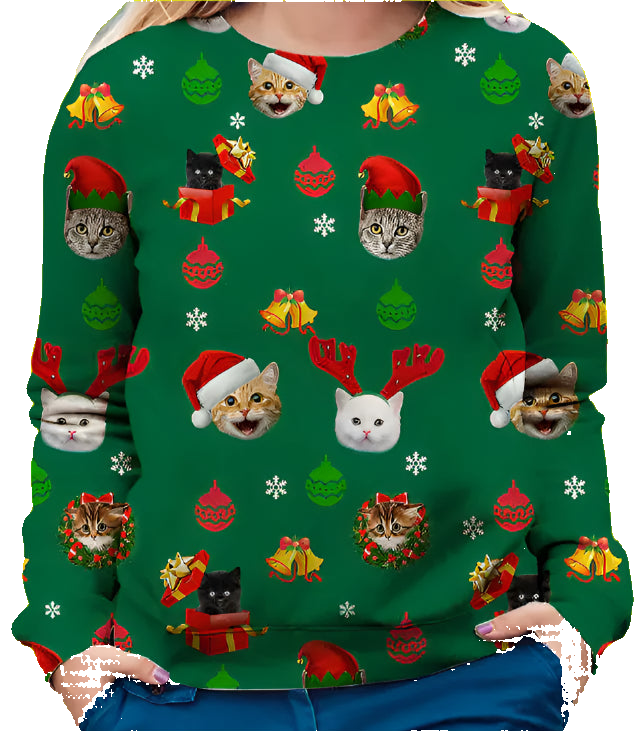 Green Christmas-themed sweater with cat illustrations worn by a person.