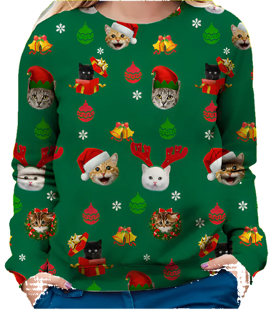 Green Christmas-themed sweater with cat illustrations worn by a person.