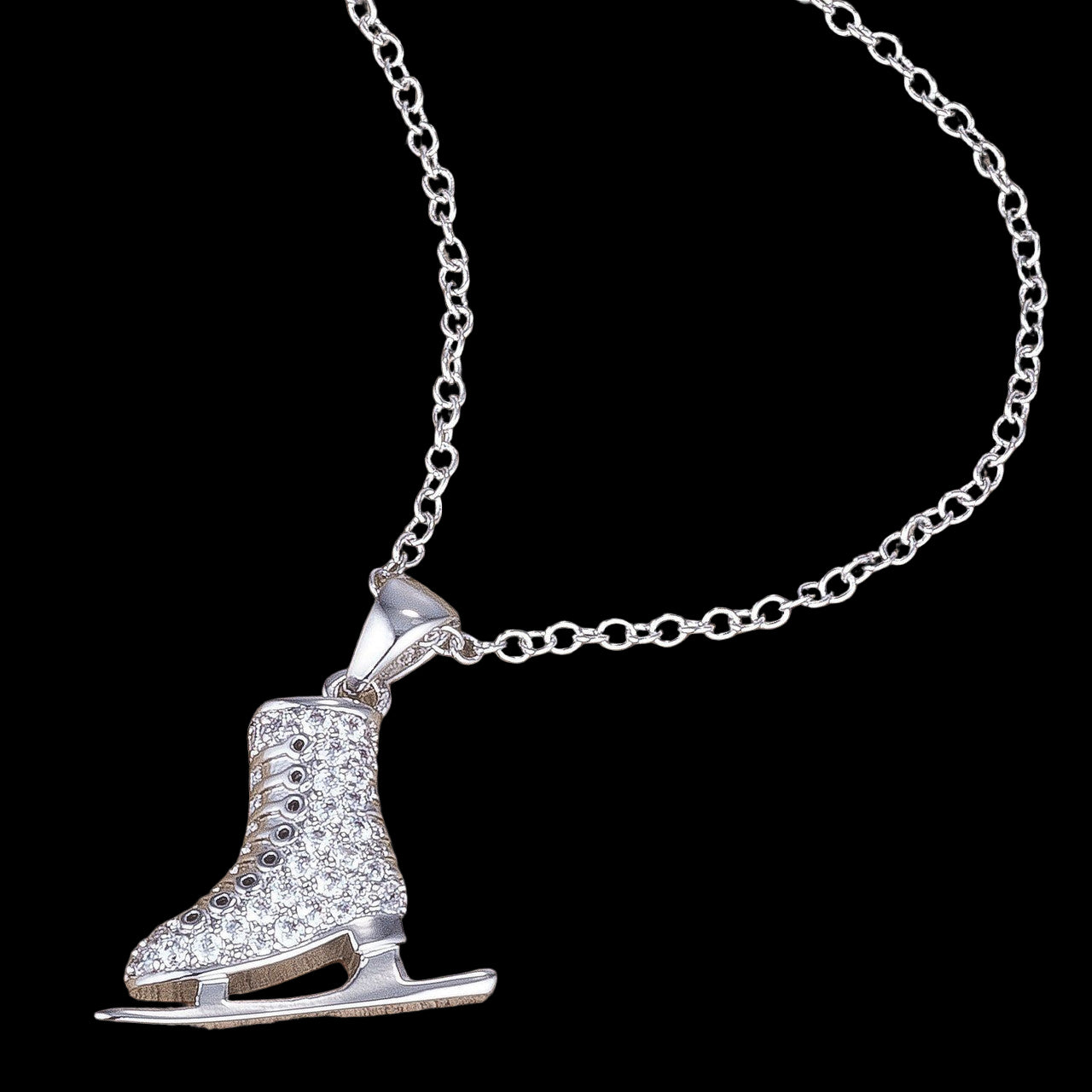 Silver ice skate pendant necklace on a wooden surface