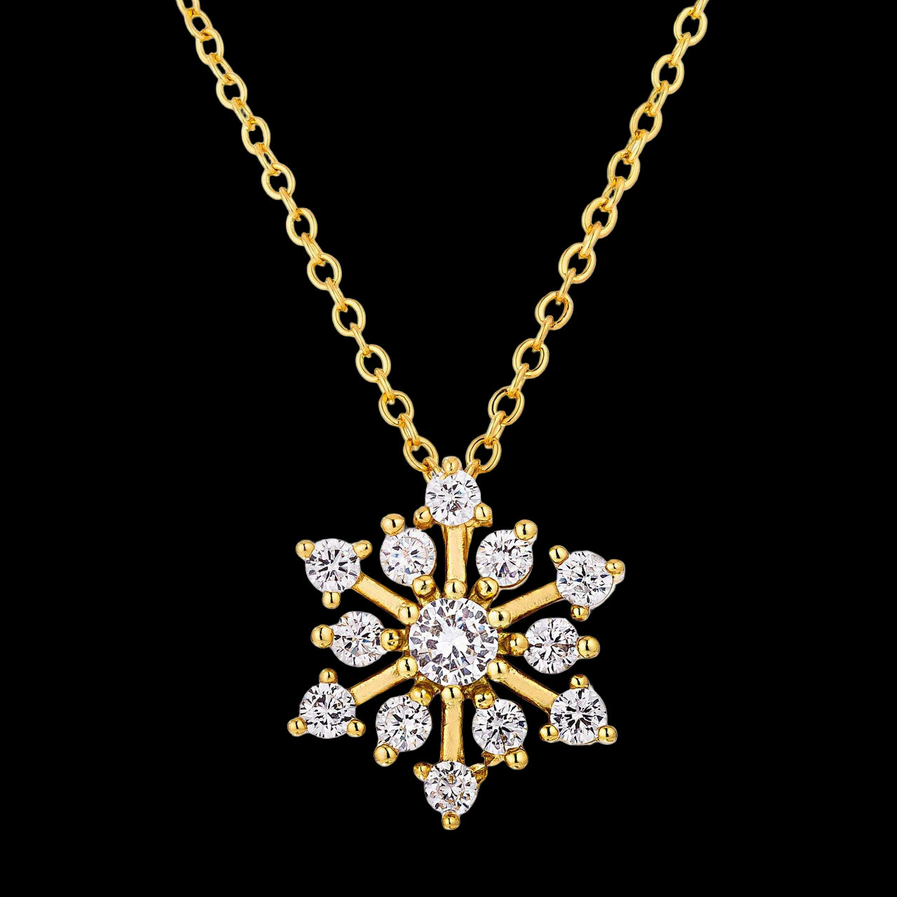 Gold snowflake pendant necklace on a white background