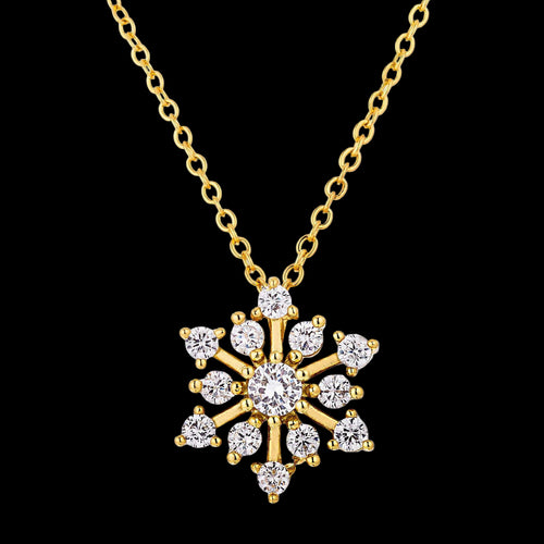 Gold snowflake pendant necklace on a white background