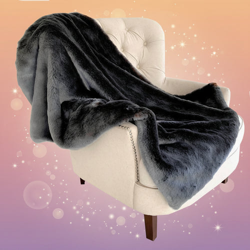 Gray plush blanket draped over a beige armchair on a white background