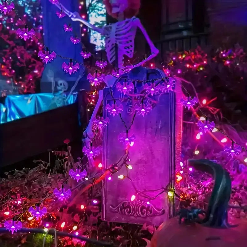 Decorative setup with skeletons, flowers, and string lights in a festive setting.