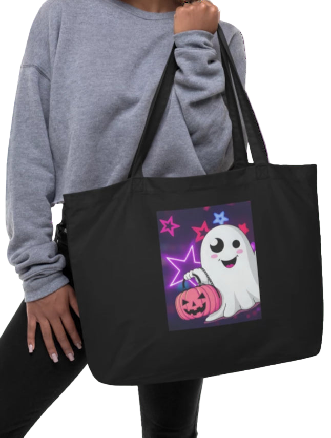 Person holding a black tote bag with a ghost design on a white background