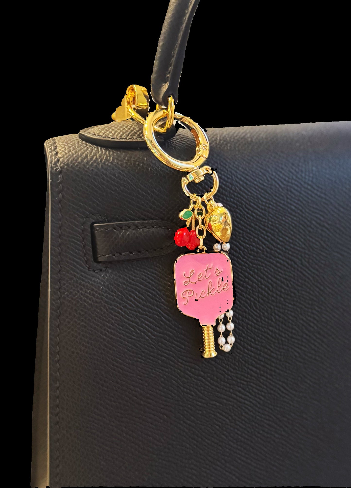 Keychain with colorful charms attached to a black handbag.