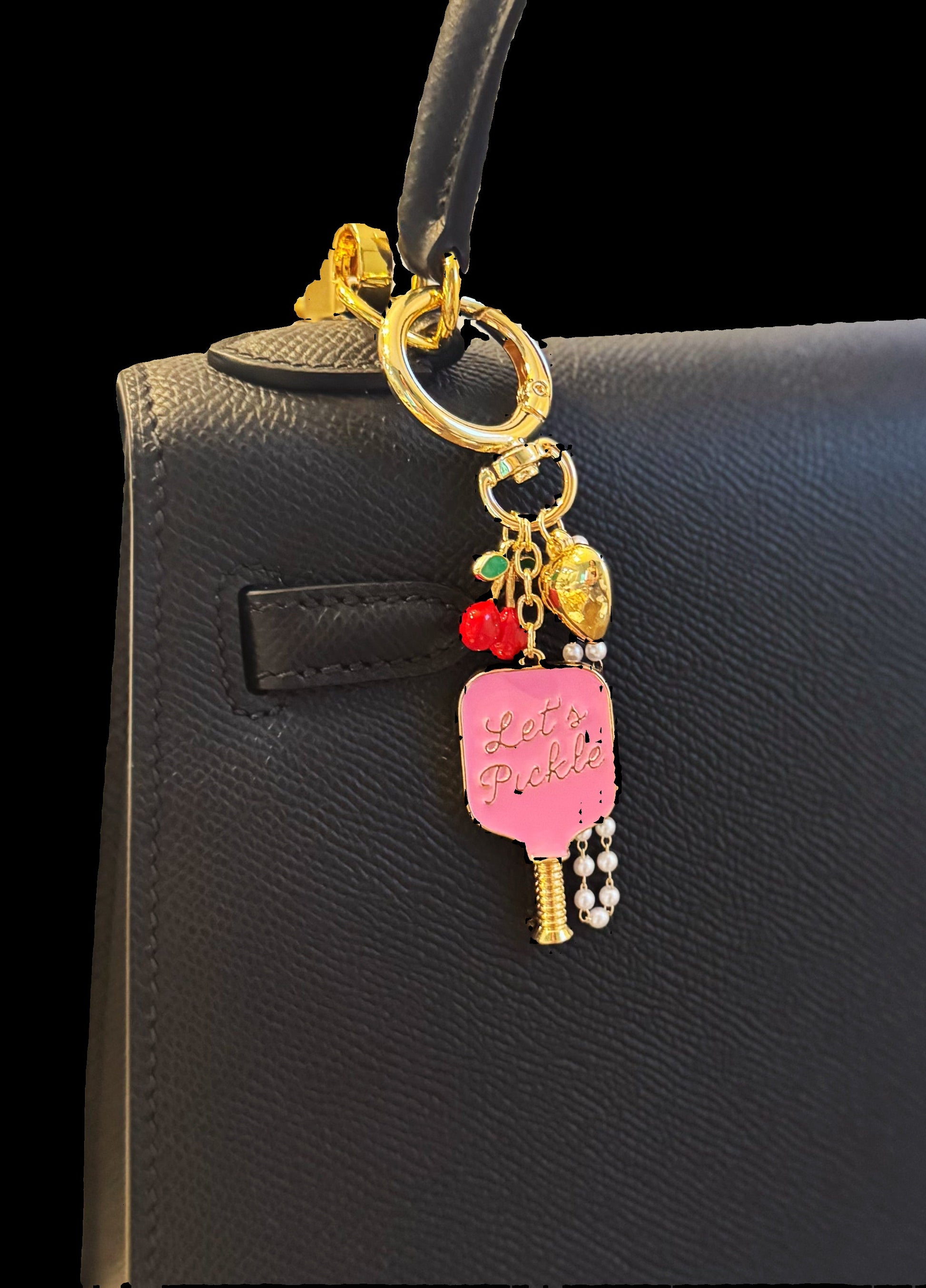 Keychain with colorful charms attached to a black handbag.