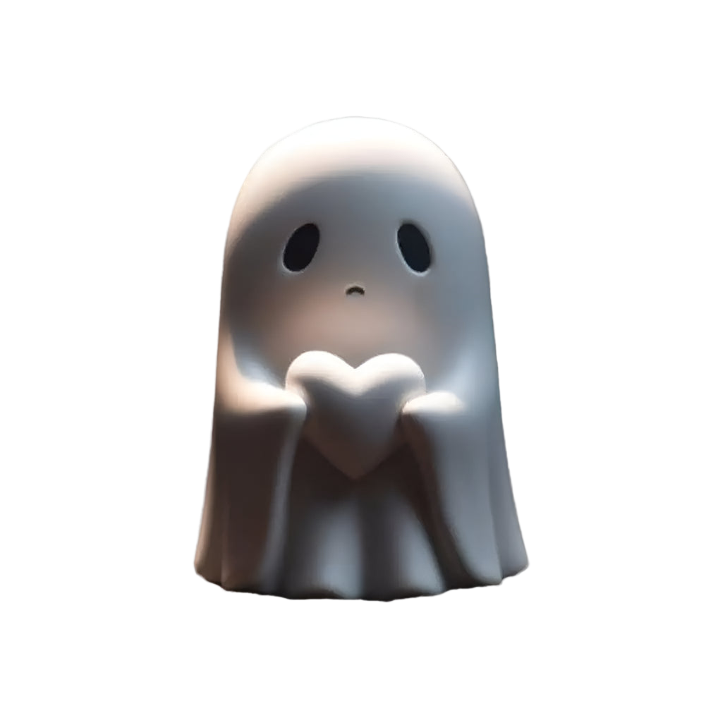 Ceramic ghost figurine holding a heart on a white background