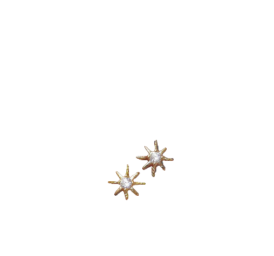 Gold sun-shaped earrings with a central diamond held between fingers on a light background