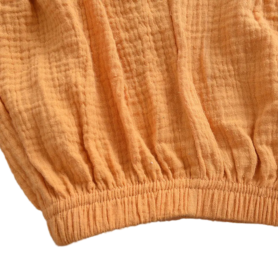 Close-up of orange textured fabric on a gray background