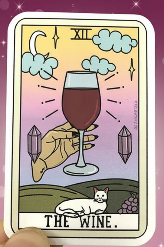 Card featuring a hand holding a glass of wine with a cat and crystals, surrounded by other tarot cards.