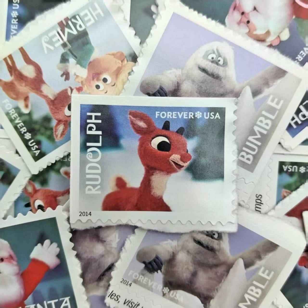 Collection of animated character stamps with a prominent Rudolph stamp in the center.