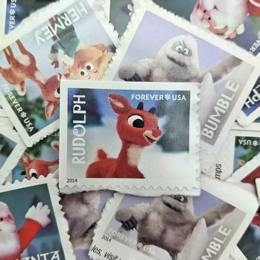 Collection of animated character stamps with a prominent Rudolph stamp in the center.