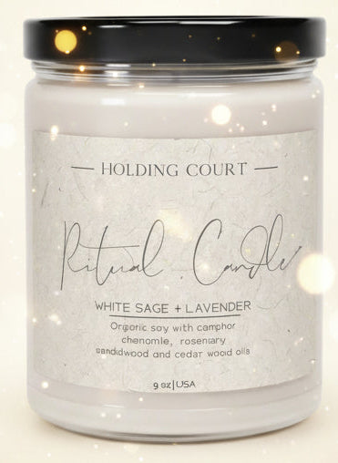 Candle jar labeled 'Holding Court' with a black lid on a neutral background