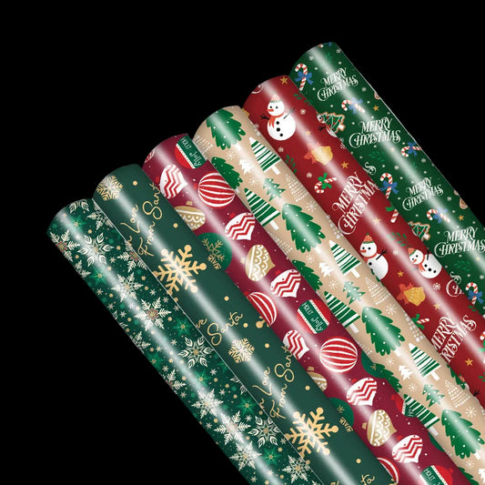 Set of Christmas-themed wrapping paper rolls on a white background