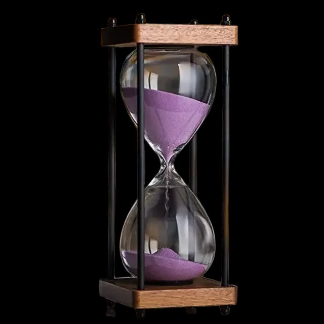 Hourglass with purple sand on a blurred background