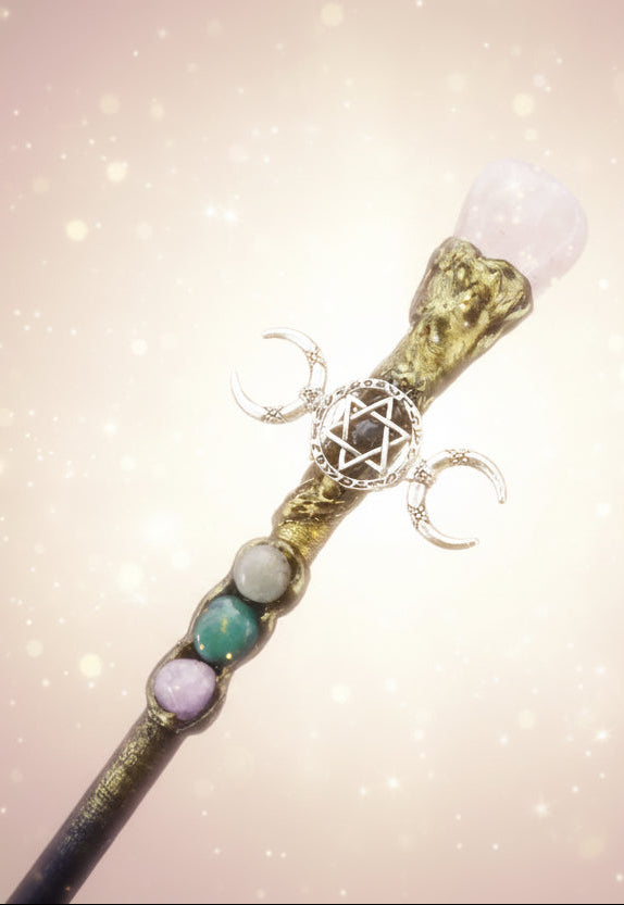 Decorative staff with mystical symbols and stones on a dark background