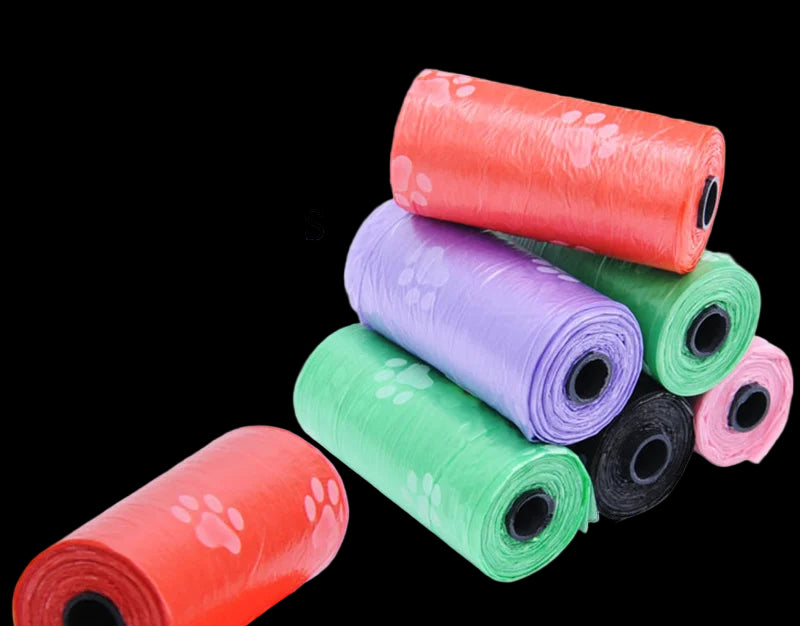 Assorted colored rolls of dog waste bags with paw prints on a white background.