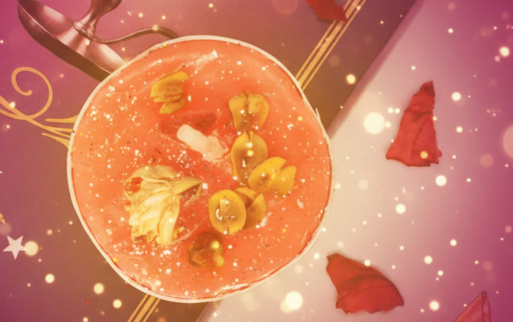 Pink cocktail with floral elements on a decorative purple and gold background