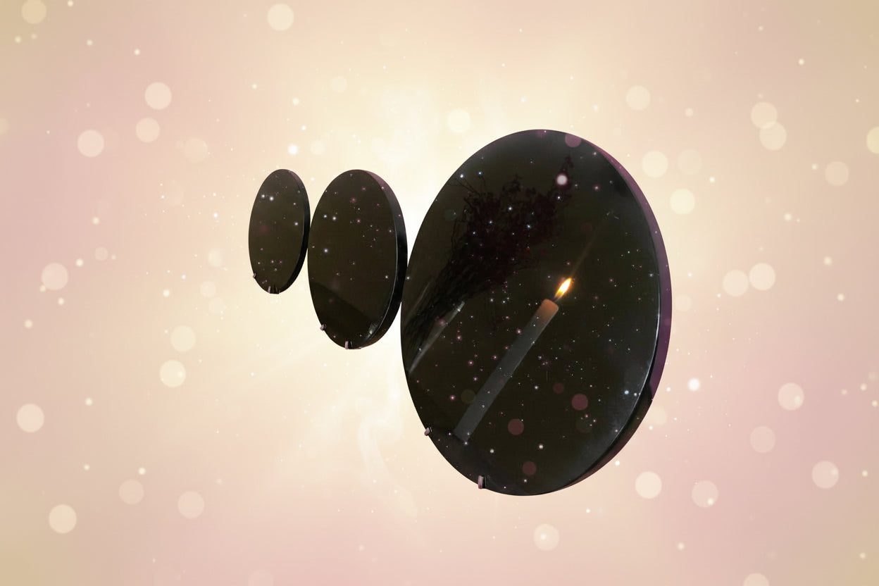 Set of black round plates on a wooden surface with a white background