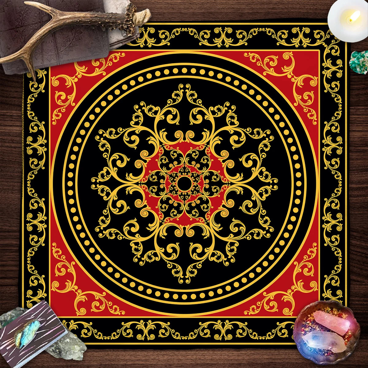 Decorative red and black mandala with gold accents on a wooden surface.