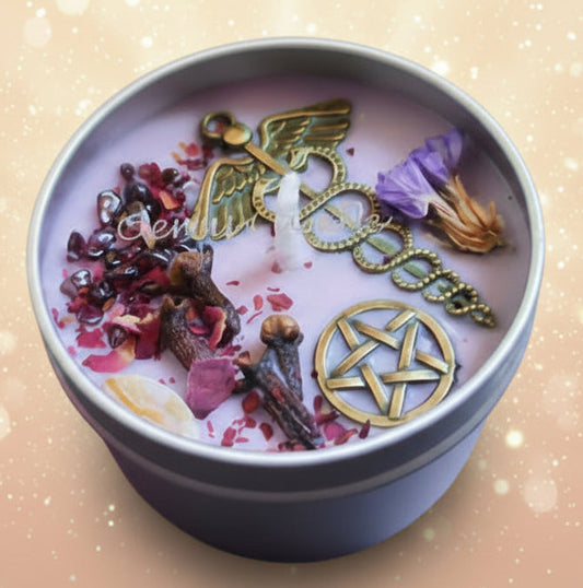 Candle with angel wings and pentacle symbol, surrounded by crystals and herbs on a mystical table.