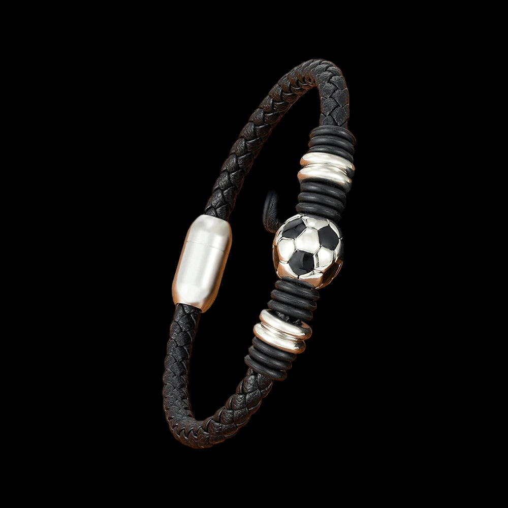 Black braided bracelet with silver and soccer ball charm on a wooden surface