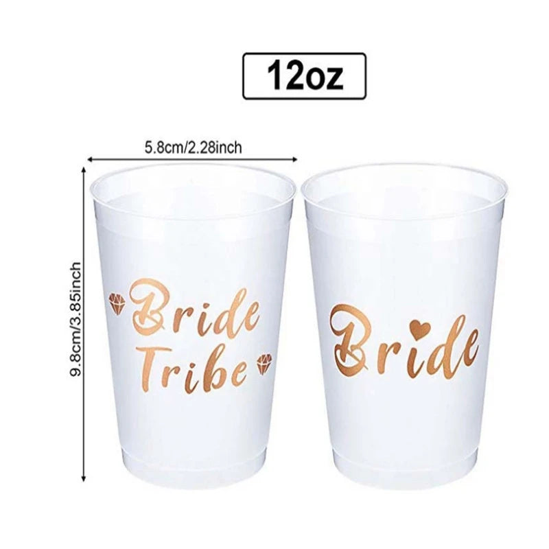 Two white cups with 'Bride Tribe' and 'Bride' text in gold, with measurements on a white background.