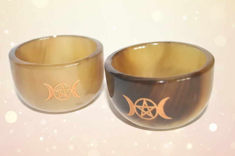 Two brown glass bowls with star designs on a white background