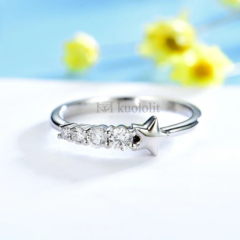 Silver ring with diamonds on a white surface with yellow flowers in the background