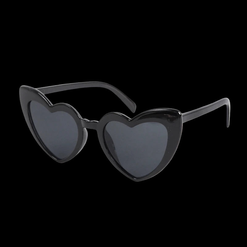 Heart-shaped sunglasses with black frames and dark lenses on a white background