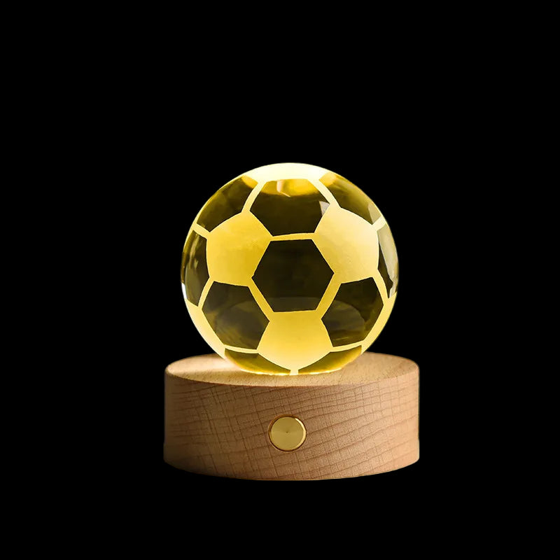 Gold soccer ball crystal on a wooden base with a dark background