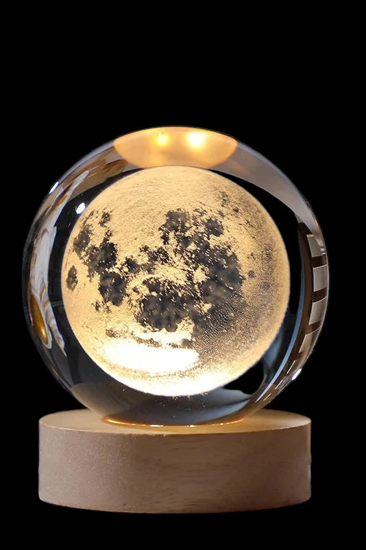 Moon lamp on a wooden base with an astronaut figure in the background