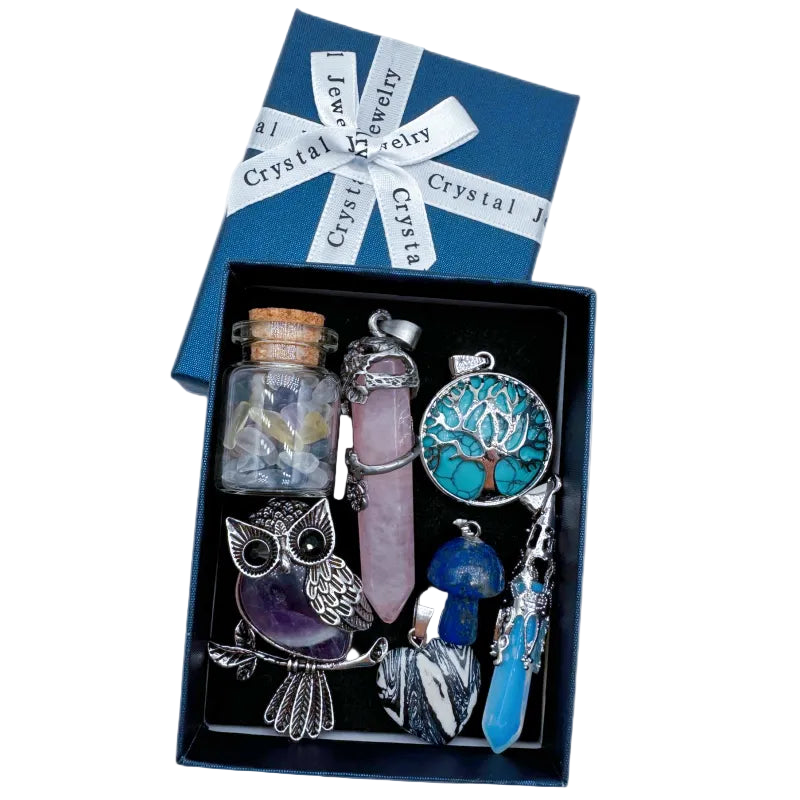Crystal jewelry set with a tree of life pendant, owl figurine, and other items in a box labeled 'Crystal Jewelry'.