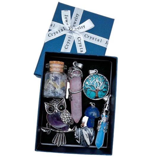 Crystal jewelry set with a tree of life pendant, owl figurine, and other items in a box labeled 'Crystal Jewelry'.