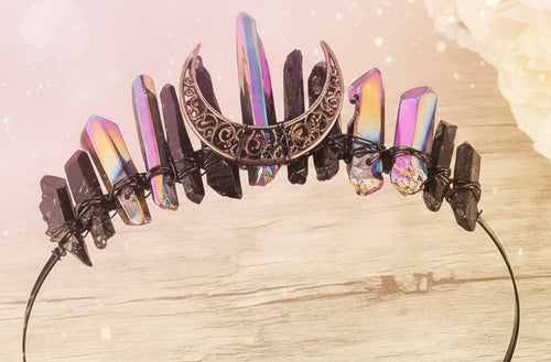 Decorative headband with rainbow and black stones on a wooden surface