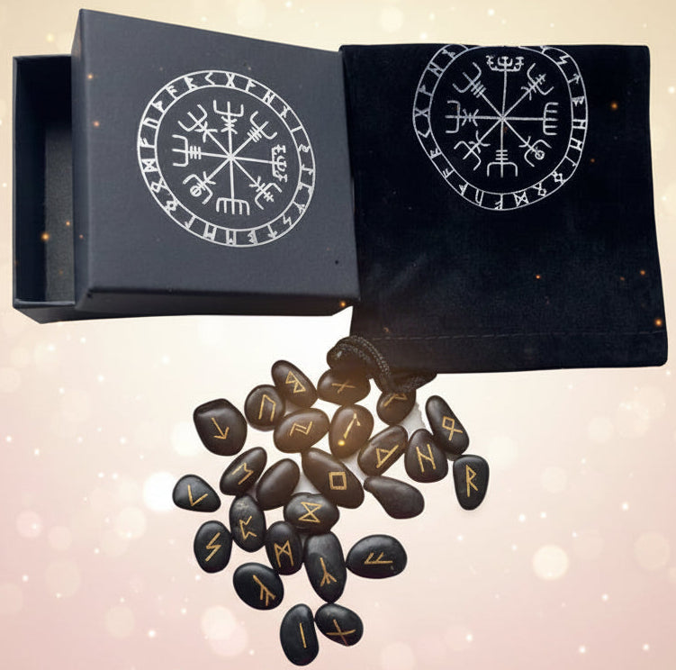 Black stones with gold runes next to a black box and pouch with similar designs.