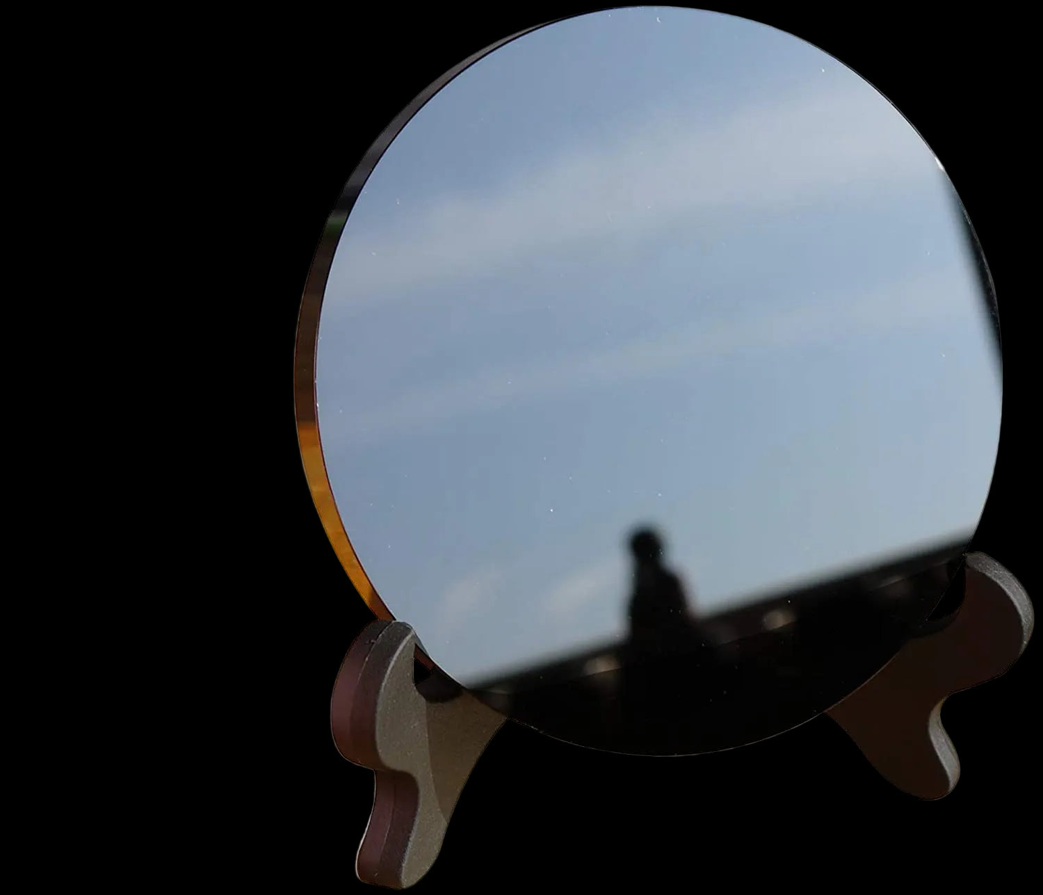 Round reflective object on a stand with a blurred background