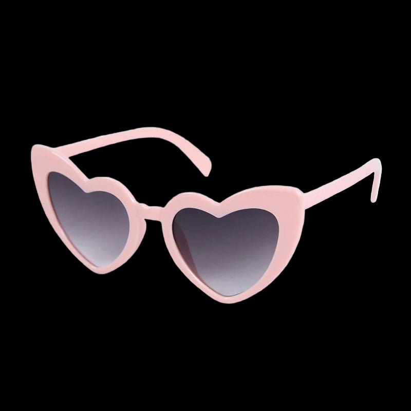 Pink heart-shaped sunglasses with black gradient lenses on a white background