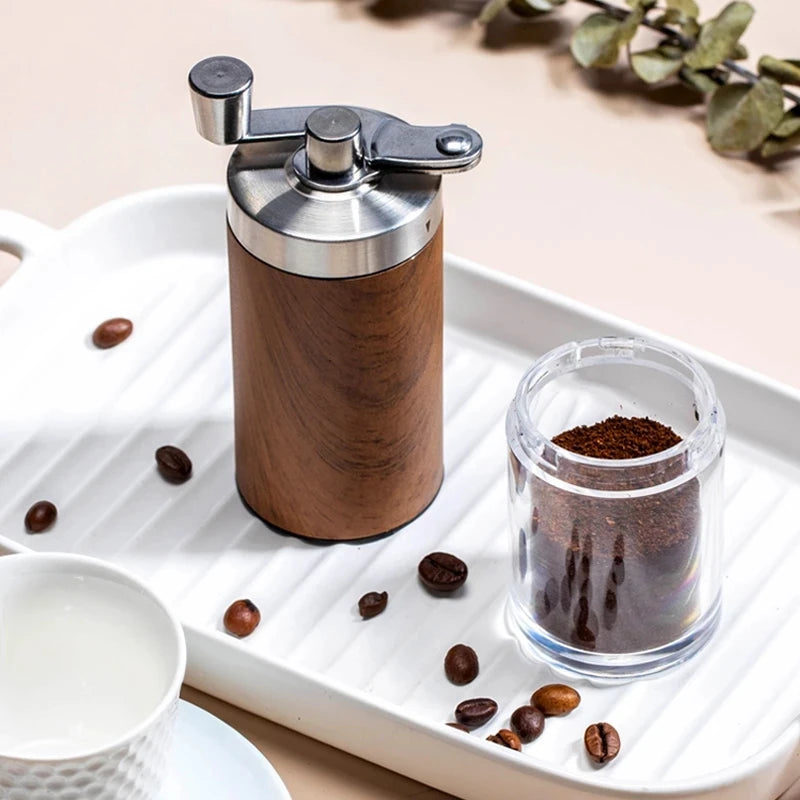 Wooden coffee grinder with ground coffee on a white tray